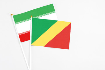 Republic Of The Congo and Iran stick flags on white background. High quality fabric, miniature national flag. Peaceful global concept.White floor for copy space.