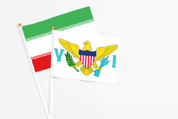 United States Virgin Islands and Iran stick flags on white background. High quality fabric, miniature national flag. Peaceful global concept.White floor for copy space.