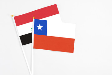 Chile and Iraq stick flags on white background. High quality fabric, miniature national flag. Peaceful global concept.White floor for copy space.