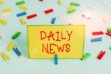 Word writing text Daily News. Business photo showcasing information or reports about recent events published everyday Colored clothespin papers empty reminder blue floor background office pin