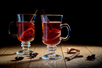 two glasses of mulled wine on a wooden surface
