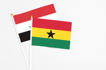 Ghana and Iraq stick flags on white background. High quality fabric, miniature national flag. Peaceful global concept.White floor for copy space.