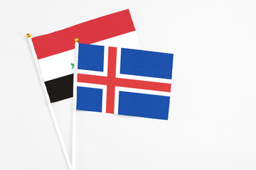 Obraz premium Iceland and Iraq stick flags on white background. High quality fabric, miniature national flag. Peaceful global concept.White floor for copy space.