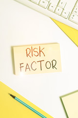 Text sign showing Risk Factor. Business photo showcasing a condition behavior or other factor that increases danger Flat lay above table with pc keyboard and copy space paper for text messages