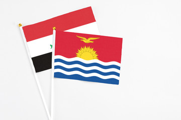 Kiribati and Iraq stick flags on white background. High quality fabric, miniature national flag. Peaceful global concept.White floor for copy space.