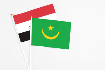 Mauritania and Iraq stick flags on white background. High quality fabric, miniature national flag. Peaceful global concept.White floor for copy space.