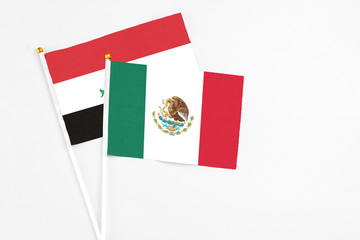 Mexico and Iraq stick flags on white background. High quality fabric, miniature national flag. Peaceful global concept.White floor for copy space.