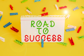 Handwriting text Road To Success. Conceptual photo studying really hard Improve yourself to reach dreams wishes Colored clothespin papers empty reminder yellow floor background office