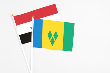Saint Vincent And The Grenadines and Iraq stick flags on white background. High quality fabric,...
