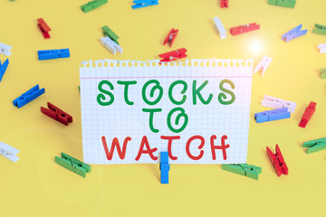 Handwriting text Stocks To Watch. Conceptual photo being heavy broker and watch every increase decrease Colored clothespin papers empty reminder yellow floor background office