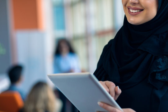 pretty modern Arabian woman with tablet computer