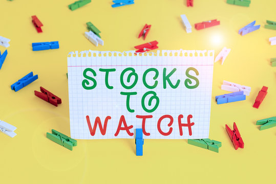 Handwriting text Stocks To Watch. Conceptual photo being heavy broker and watch every increase decrease Colored clothespin papers empty reminder yellow floor background office