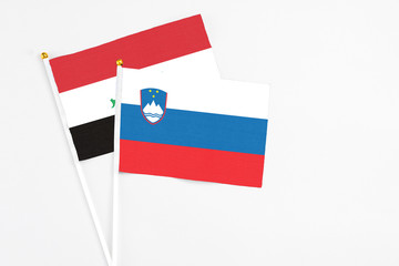 Slovenia and Iraq stick flags on white background. High quality fabric, miniature national flag. Peaceful global concept.White floor for copy space.