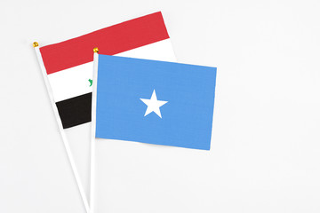Somalia and Iraq stick flags on white background. High quality fabric, miniature national flag. Peaceful global concept.White floor for copy space.