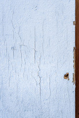Closeup old weathered, and cracked paint, wood siding removed as part of siding project