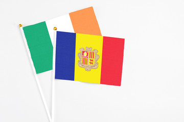 Andorra and Ireland stick flags on white background. High quality fabric, miniature national flag. Peaceful global concept.White floor for copy space