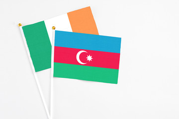 Azerbaijan and Ireland stick flags on white background. High quality fabric, miniature national flag. Peaceful global concept.White floor for copy space