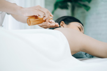 Beautiful young woman lying down on beds massage and spa at asian spa massage and beauty salon center, spa concept, massage concept