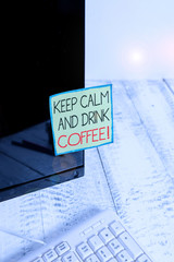 Handwriting text Keep Calm And Drink Coffee. Conceptual photo encourage demonstrating to enjoy caffeine drink and relax Notation paper taped to black computer monitor screen near white keyboard