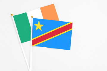 Congo and Ireland stick flags on white background. High quality fabric, miniature national flag. Peaceful global concept.White floor for copy space