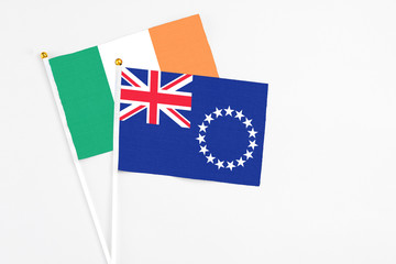 Cook Islands and Ireland stick flags on white background. High quality fabric, miniature national flag. Peaceful global concept.White floor for copy space