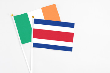 Costa Rica and Ireland stick flags on white background. High quality fabric, miniature national flag. Peaceful global concept.White floor for copy space