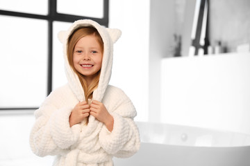 Cute little girl in bathroom. Space for text
