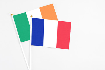 France and Ireland stick flags on white background. High quality fabric, miniature national flag. Peaceful global concept.White floor for copy space