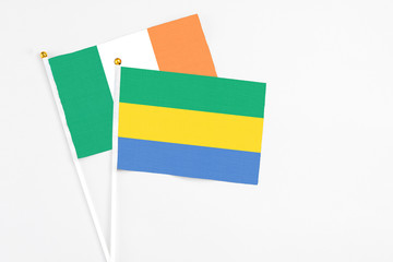 Gabon and Ireland stick flags on white background. High quality fabric, miniature national flag....