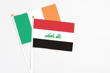 Iraq and Ireland stick flags on white background. High quality fabric, miniature national flag. Peaceful global concept.White floor for copy space