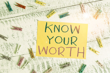 Conceptual hand writing showing Know Your Worth. Concept meaning Be aware of demonstratingal value Deserved income salary benefits Colored clothespin rectangle shaped paper blue background