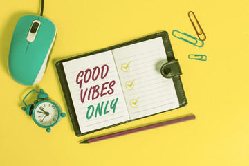 Word writing text Good Vibes Only. Business photo showcasing Just positive emotions feelings No negative energies Locked diary sheets clips marker mouse alarm clock colored background