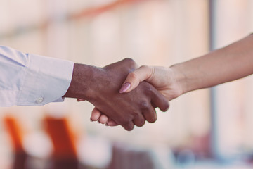 Handshake between african and a caucasian man.