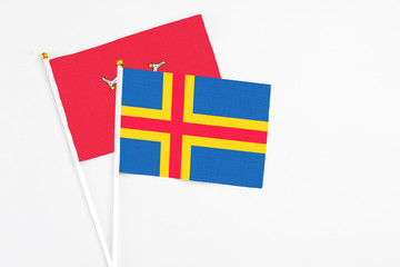 Aland Islands and Isle Of Man stick flags on white background. High quality fabric, miniature...