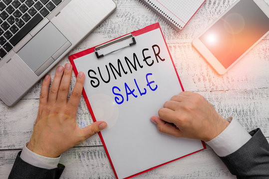 Word writing text Summer Sale. Business photo showcasing time when a store sells products at much lower prices than usual Hand hold writing equipment tool near modern high technology laptop device