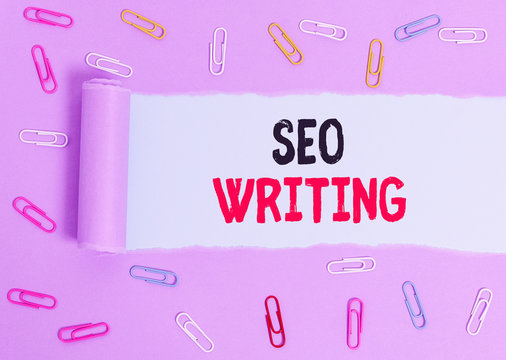 Conceptual hand writing showing Seo Writing. Concept meaning grabbing the attention of the search engines using specific word Paper clip and torn cardboard on wood classic table backdrop