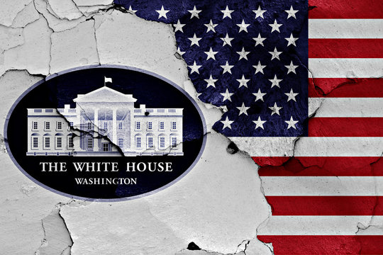 flags of White House Office and USA painted on cracked wall