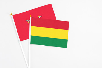 Bolivia and Isle Of Man stick flags on white background. High quality fabric, miniature national flag. Peaceful global concept.White floor for copy space.
