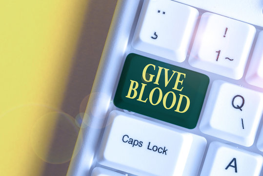 Handwriting text Give Blood. Conceptual photo demonstrating voluntarily has blood drawn and used for transfusions White pc keyboard with empty note paper above white background key copy space