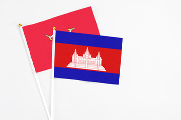 Cambodia and Isle Of Man stick flags on white background. High quality fabric, miniature national...
