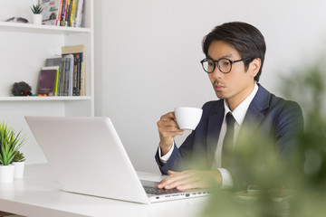 Asian Businessman Wear Eyeglasses with Coffee Cup