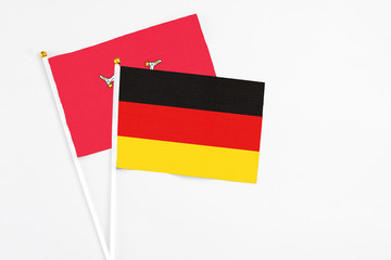 Germany and Isle Of Man stick flags on white background. High quality fabric, miniature national flag. Peaceful global concept.White floor for copy space.