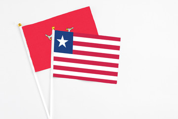 Liberia and Isle Of Man stick flags on white background. High quality fabric, miniature national...