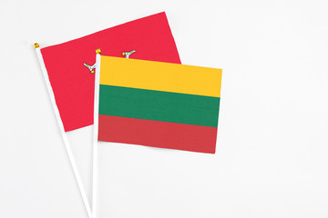 Lithuania and Isle Of Man stick flags on white background. High quality fabric, miniature national flag. Peaceful global concept.White floor for copy space.