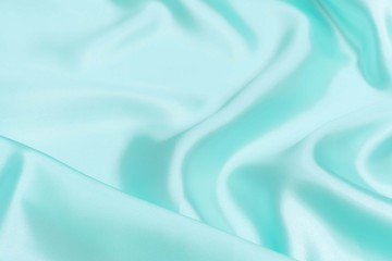 Obraz premium Cyan-Teal satin fabric texture soft blur background