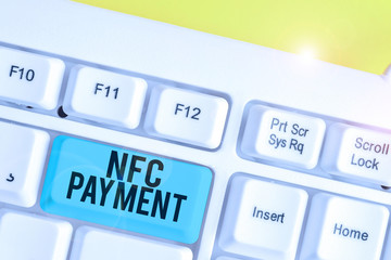 Conceptual hand writing showing Nfc Payment. Concept meaning contactless payment that use nearfield communication technology White pc keyboard with note paper above the white background