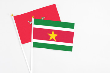 Suriname and Isle Of Man stick flags on white background. High quality fabric, miniature national...