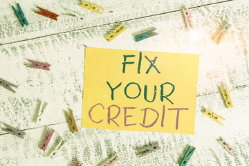 Conceptual hand writing showing Fix Your Credit. Concept meaning Keep balances low on credit cards and other credit Colored clothespin rectangle shaped paper blue background