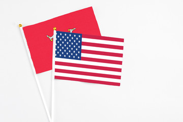 United States and Isle Of Man stick flags on white background. High quality fabric, miniature national flag. Peaceful global concept.White floor for copy space.