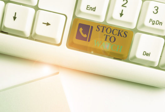 Text sign showing Stocks To Watch. Business photo showcasing being heavy broker and watch every increase decrease White pc keyboard with empty note paper above white background key copy space